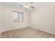 Bedroom with a ceiling fan and window with blinds, offering a comfortable and airy atmosphere at 2406 W Tallgrass Trl, Phoenix, AZ 85085