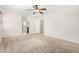 Bedroom featuring neutral carpeting, a ceiling fan, and an open doorway to another room at 2406 W Tallgrass Trl, Phoenix, AZ 85085