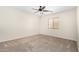 Neutral bedroom with carpet, fan, and a window providing natural light at 2406 W Tallgrass Trl, Phoenix, AZ 85085