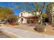 Beautiful two-story home featuring desert landscaping, a tiled roof, and brick paved driveway at 2406 W Tallgrass Trl, Phoenix, AZ 85085