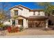 Inviting two-story home with a brown tiled roof, desert landscaping and a brick paved driveway at 2406 W Tallgrass Trl, Phoenix, AZ 85085