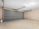 This garage has a painted floor and walls, and a gray garage door at 2406 W Tallgrass Trl, Phoenix, AZ 85085