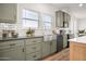 Modern kitchen with farmhouse sink, gray cabinets, and stainless-steel appliances at 2723 S 357Th Dr, Tonopah, AZ 85354