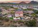 Expansive aerial view of a home with a basketball court, turf lawn, pool, pergola, and mountain views at 28826 N 67Th Dr, Peoria, AZ 85383