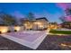 Backyard basketball court, grassy area, and patio area, creating an active space for sports and outdoor gatherings in evening at 28826 N 67Th Dr, Peoria, AZ 85383