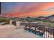 Outdoor balcony with sunset views, a seating area, and views of the mountains at 28826 N 67Th Dr, Peoria, AZ 85383