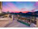 Balcony view overlooking a backyard pool, patio, and beautiful mountain views at sunset at 28826 N 67Th Dr, Peoria, AZ 85383