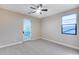 Bedroom features gray carpet, neutral paint and a glass door to the outside at 28826 N 67Th Dr, Peoria, AZ 85383