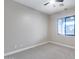 Bedroom featuring neutral carpet, a ceiling fan, and a view to the outside at 28826 N 67Th Dr, Peoria, AZ 85383