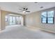 Spacious bonus room with neutral carpet, a ceiling fan, and French doors at 28826 N 67Th Dr, Peoria, AZ 85383