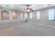 Spacious bonus room with neutral carpet, arched doorway and many windows at 28826 N 67Th Dr, Peoria, AZ 85383