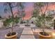 Beautiful courtyard featuring a central water fountain, brick pathways, and serene landscaping at sunset at 28826 N 67Th Dr, Peoria, AZ 85383