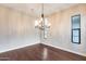 Dining room with hardwood floors, a chandelier, and a window offering ample natural light at 28826 N 67Th Dr, Peoria, AZ 85383