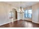 Dining space featuring hardwood floors, a chandelier, and archways leading to other rooms at 28826 N 67Th Dr, Peoria, AZ 85383