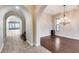 A dining room boasts wood floors, an elegant chandelier, and an archway entrance at 28826 N 67Th Dr, Peoria, AZ 85383