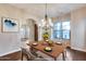 Traditional dining room with natural light, chandelier, and hardwood floors at 28826 N 67Th Dr, Peoria, AZ 85383