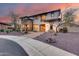 Elegant two-story home with stone accents, balconies, desert landscaping and a paver driveway at 28826 N 67Th Dr, Peoria, AZ 85383