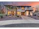 Elegant home with stone accents, balconies, a three-car garage, and desert landscaping under a vibrant sky at 28826 N 67Th Dr, Peoria, AZ 85383