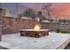 Custom fire pit with stone surround offers a cozy and inviting outdoor gathering spot at 28826 N 67Th Dr, Peoria, AZ 85383