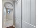 Hallway with arched doorway leading to carpeted bedroom and a white closet door at 28826 N 67Th Dr, Peoria, AZ 85383