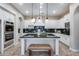 Bright and airy kitchen featuring white cabinets, stainless steel appliances, a large island, and pendant lighting at 28826 N 67Th Dr, Peoria, AZ 85383