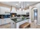 Bright kitchen boasts white cabinetry, granite countertops, stainless steel appliances, and a kitchen island with seating at 28826 N 67Th Dr, Peoria, AZ 85383