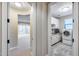 Bright laundry room with cabinetry, sink, and modern washer and dryer appliances at 28826 N 67Th Dr, Peoria, AZ 85383