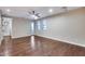 Bright living room with hardwood floors, modern ceiling fan, and access to an outdoor balcony at 28826 N 67Th Dr, Peoria, AZ 85383