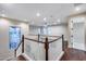 Open-concept living room featuring hardwood floors and a staircase with wooden and white balustrades at 28826 N 67Th Dr, Peoria, AZ 85383