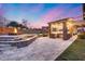 Well-designed outdoor kitchen area with stone accents, fire pit, and inviting patio space at 28826 N 67Th Dr, Peoria, AZ 85383