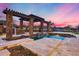 Outdoor swimming pool with stone accents and a pergola, set in beautifully landscaped backyard for summer relaxation at 28826 N 67Th Dr, Peoria, AZ 85383