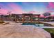 Backyard pool featuring stone pillars and archways, creating a luxurious oasis for relaxation and leisure in the sunset at 28826 N 67Th Dr, Peoria, AZ 85383