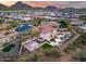 Aerial view of backyard with pool, basketball court, multiple outdoor lounge areas, and mountain views at 28826 N 67Th Dr, Peoria, AZ 85383