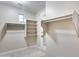 Large walk-in closet with custom shelving, hanging rods and natural light at 28826 N 67Th Dr, Peoria, AZ 85383