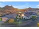 Single-story home with pool, turf, desert landscaping, and a fenced yard, set against a mountain backdrop at 297 W Chase St, San Tan Valley, AZ 85143