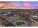 Aerial view showcasing the property's pool, outdoor recreation area, solar panels, and desert surroundings at 297 W Chase St, San Tan Valley, AZ 85143