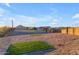 Expansive backyard featuring desert landscaping, artificial turf accents, and a charming single-story house at 297 W Chase St, San Tan Valley, AZ 85143