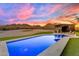 Beautiful pool and deck with outdoor seating, with mountain views beyond the landscaped backyard at 297 W Chase St, San Tan Valley, AZ 85143