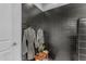 Bathroom featuring a walk-in shower with black subway tile, gray robes, and a wood bench at 297 W Chase St, San Tan Valley, AZ 85143