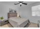 Comfortable bedroom featuring a bed with a headboard, side table, and a decorative print on the wall at 297 W Chase St, San Tan Valley, AZ 85143