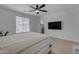 Bright bedroom featuring a ceiling fan and a TV mounted on the wall at 297 W Chase St, San Tan Valley, AZ 85143