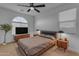 Stylish bedroom featuring a mid-century modern bed, lamps, side tables, and a large window at 297 W Chase St, San Tan Valley, AZ 85143