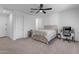 Cozy bedroom with ceiling fan, neutral walls, and a comfortable bed frame with built-in storage at 297 W Chase St, San Tan Valley, AZ 85143