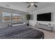 Bedroom features a ceiling fan, stylish wall trim and desert views at 297 W Chase St, San Tan Valley, AZ 85143