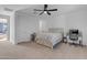 Bedroom featuring a ceiling fan, a comfortable bed frame with built-in storage, and a white door at 297 W Chase St, San Tan Valley, AZ 85143