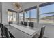 Bright dining room boasts views, modern light fixture and seating for eight at 297 W Chase St, San Tan Valley, AZ 85143