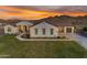 Inviting single-story home features desert landscaping, a tile roof, and a spacious three-car garage at 297 W Chase St, San Tan Valley, AZ 85143