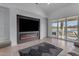 Bright living room features an electric fireplace, a large TV, and outdoor access at 297 W Chase St, San Tan Valley, AZ 85143