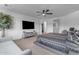 Spacious main bedroom features a ceiling fan, TV, sitting area, and ensuite bathroom with modern finishes at 297 W Chase St, San Tan Valley, AZ 85143