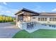 Backyard outdoor kitchen featuring a built-in grill, bar seating, and a refreshing pool at 297 W Chase St, San Tan Valley, AZ 85143